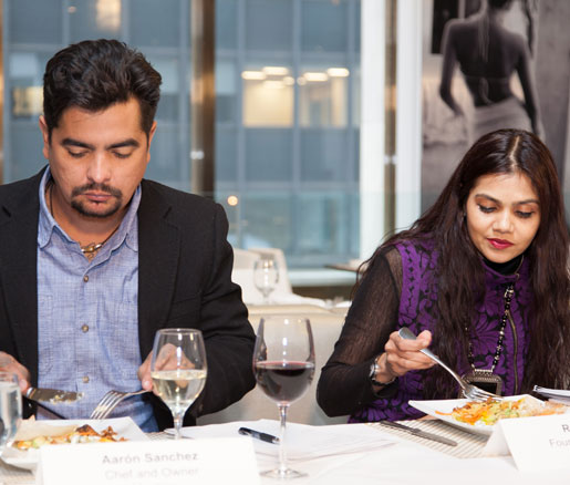 Judges Aarón Sánchez and Rohini Dey evaluate a competitor's dish