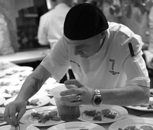 A visiting chef plates food in the James Beard House kitchen