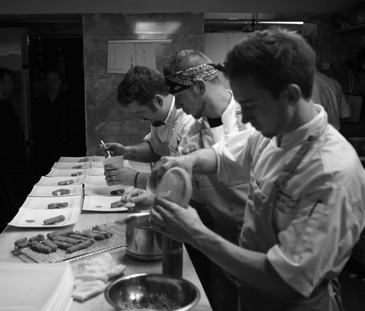 Chefs assemble dishes in the James Beard House kitchen