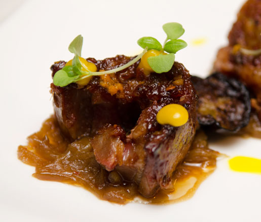 Moroccan barbecued lamb belly with housemade harissa caramelized onions, Japanese eggplant, and orange curd 